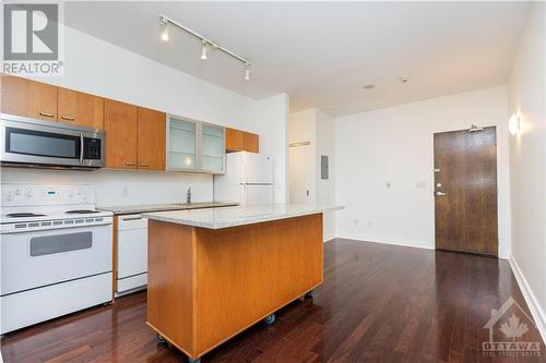 Open living area seamlessly connects with dining and kitchen spaces. - 383 Cumberland Street Unit#710, Ottawa, ON - Indoor Photo Showing Kitchen