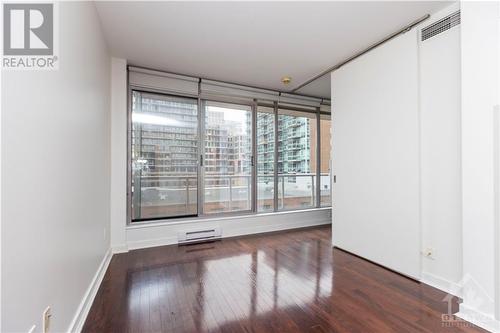 This 1-bedroom condo boasts rich hardwood floors, granite countertops, and a flexible kitchen layout for cooking and entertaining. - 383 Cumberland Street Unit#710, Ottawa, ON - Indoor Photo Showing Other Room