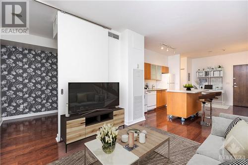 Experience urban living at its finest with this modern condo featuring high ceilings, hardwood floors, and a prime downtown location. - 383 Cumberland Street Unit#710, Ottawa, ON - Indoor Photo Showing Living Room