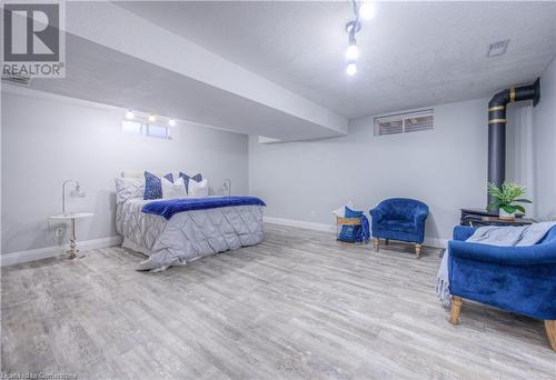 Bedroom featuring wood-type flooring and a textured ceiling - 83 Bridlewreath Street, Kitchener, ON - Indoor