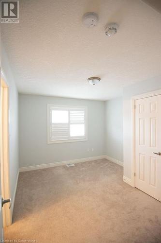 Carpeted spare room with a textured ceiling - 839 Autumn Willow Drive, Waterloo, ON - Indoor Photo Showing Other Room