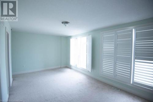 Empty room with a textured ceiling and light carpet - 839 Autumn Willow Drive, Waterloo, ON - Indoor Photo Showing Other Room