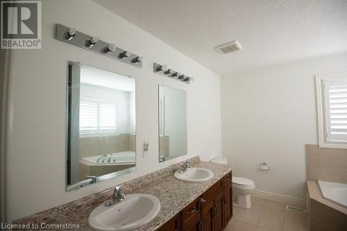 Bathroom featuring toilet, tile patterned floors, a tub, a textured ceiling, and vanity - 839 Autumn Willow Drive, Waterloo, ON - Indoor Photo Showing Bathroom