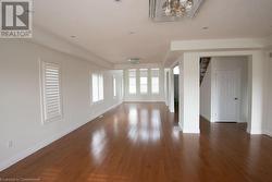 Unfurnished living room featuring dark hardwood / wood-style floors and a textured ceiling - 