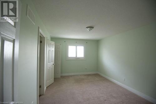 Unfurnished bedroom with light colored carpet and a textured ceiling - 839 Autumn Willow Drive, Waterloo, ON - Indoor Photo Showing Other Room