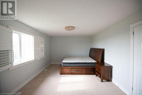 Unfurnished bedroom with light colored carpet and built in desk - 839 Autumn Willow Drive, Waterloo, ON - Indoor