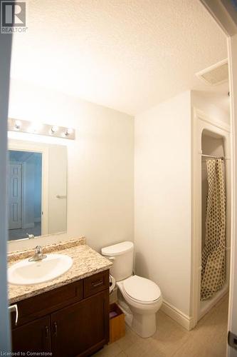 Bathroom featuring tile patterned floors, vanity, a textured ceiling, curtained shower, and toilet - 839 Autumn Willow Drive, Waterloo, ON - Indoor Photo Showing Bathroom