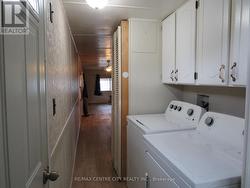 washer and dryer and cupboards above - 