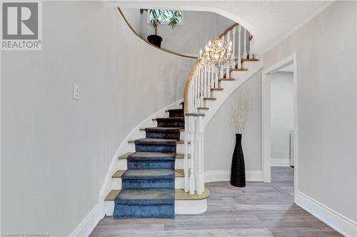 Staircase with an inviting chandelier, hardwood / wood-style floors, and a textured ceiling - 139 Shady Pine Circle, Brampton, ON - Indoor Photo Showing Other Room