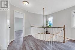 Corridor with a textured ceiling and hardwood / wood-style flooring - 