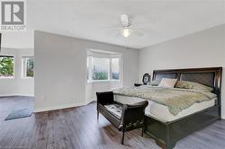 Bedroom with wood-type flooring and ceiling fan - 