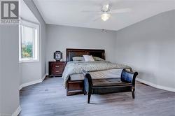 Bedroom with hardwood / wood-style flooring and ceiling fan - 