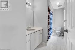 Bathroom featuring vanity, tile patterned flooring, and toilet - 