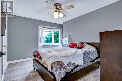 Bedroom featuring a textured ceiling, light wood-type flooring, and ceiling fan - 139 Shady Pine Circle, Brampton, ON - Indoor Photo Showing Bedroom