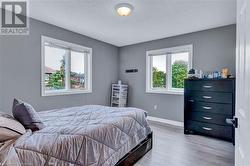 Bedroom with wood-type flooring and a textured ceiling - 