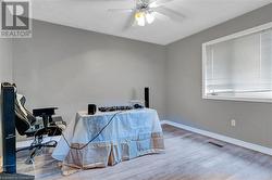 Office featuring hardwood / wood-style floors, ceiling fan, and a textured ceiling - 