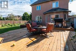 Wooden deck featuring a grill - 