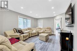 Living room featuring a textured ceiling and light wood-type flooring - 