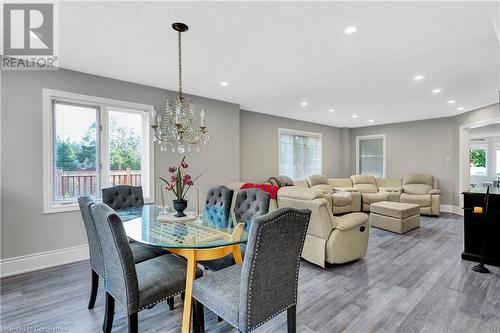 Dining area with a wealth of natural light, hardwood / wood-style flooring, and an inviting chandelier - 139 Shady Pine Circle, Brampton, ON - Indoor Photo Showing Dining Room