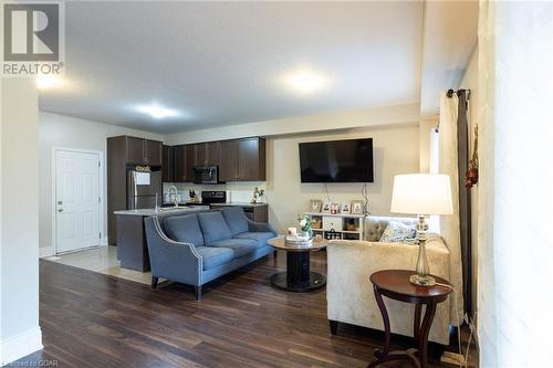 Living room featuring dark wood-type flooring and sink - 135 Samuel Drive, Arthur, ON 