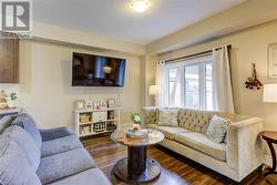 Living room with dark hardwood / wood-style flooring and a textured ceiling - 