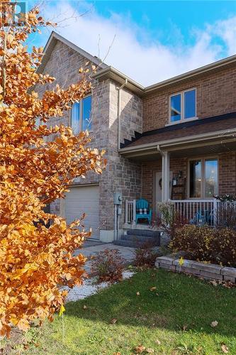 View of front of house with covered porch and a garage - 135 Samuel Drive, Arthur, ON 