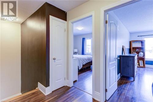 Hall featuring a textured ceiling and dark wood-type flooring - 135 Samuel Drive, Arthur, ON 