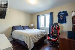 Bedroom with dark wood-type flooring - 