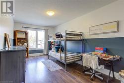 Bedroom featuring dark wood-type flooring and a textured ceiling - 