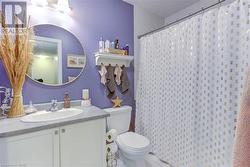 Bathroom featuring vanity, toilet, and walk in shower - 