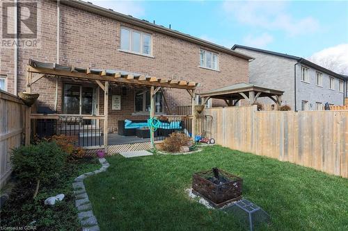 Rear view of property featuring a gazebo, a yard, an outdoor living space with a fire pit, and a patio - 135 Samuel Drive, Arthur, ON 