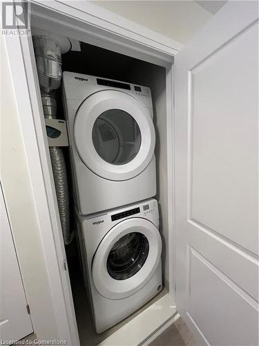 Laundry area with stacked washer and clothes dryer - 25 Isherwood Avenue Unit# 42, Cambridge, ON 