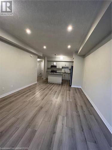 Unfurnished living room with hardwood / wood-style floors and a textured ceiling - 25 Isherwood Avenue Unit# 42, Cambridge, ON 