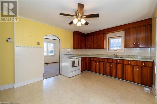 Kitchen with ornamental molding, a healthy amount of sunlight, sink, and electric range - 1710 7Th Avenue E, Owen Sound, ON - Indoor Photo Showing Kitchen With Double Sink