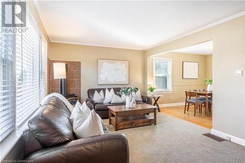 Living room with a wood stove, hardwood / wood-style flooring, and crown molding - 645 Weber Street E, Kitchener, ON - Indoor Photo Showing Living Room