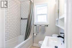 Full bathroom with sink, toilet, and shower / tub combo with curtain - 