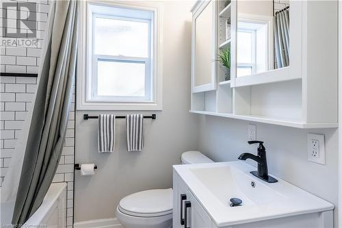 Full bathroom with plenty of natural light, vanity, shower / bath combination with curtain, and toilet - 645 Weber Street E, Kitchener, ON - Indoor Photo Showing Bathroom