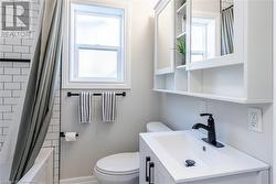 Full bathroom with plenty of natural light, vanity, shower / bath combination with curtain, and toilet - 