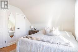 Bedroom featuring hardwood / wood-style flooring and vaulted ceiling - 