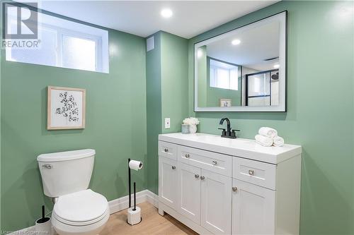 Bathroom featuring plenty of natural light, vanity, hardwood / wood-style flooring, and toilet - 645 Weber Street E, Kitchener, ON - Indoor Photo Showing Bathroom