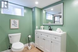 Bathroom featuring plenty of natural light, vanity, hardwood / wood-style flooring, and toilet - 