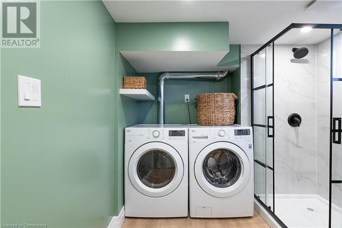 Laundry area with light wood-type flooring and washing machine and dryer - 645 Weber Street E, Kitchener, ON - Indoor Photo Showing Laundry Room