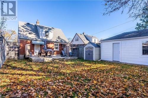 Rear view of house featuring a storage shed, a wooden deck, and a yard - 645 Weber Street E, Kitchener, ON - Outdoor