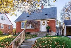 View of front of house with cooling unit and a front yard - 