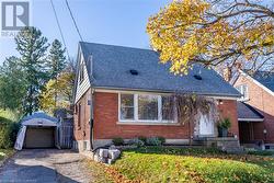 View of front of house featuring a garage and an outbuilding - 