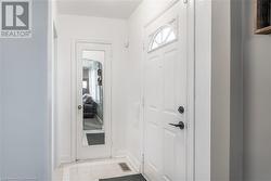 Doorway featuring light tile patterned floors - 