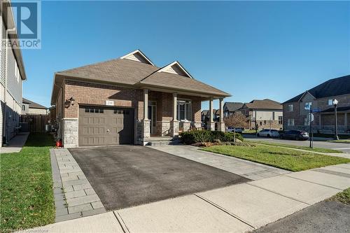 View of front of property with a garage, a porch, and a front yard - 219 Falconridge Drive, Waterloo, ON - Outdoor