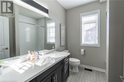 Bathroom with tiled shower, vanity, toilet, and a healthy amount of sunlight - 219 Falconridge Drive, Waterloo, ON - Indoor Photo Showing Bathroom