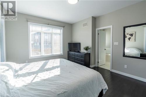 Bedroom with ensuite bath and dark wood-type flooring - 219 Falconridge Drive, Waterloo, ON - Indoor Photo Showing Bedroom