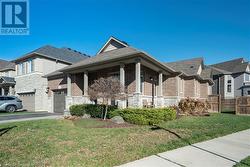 View of front facade with a front yard and a garage - 